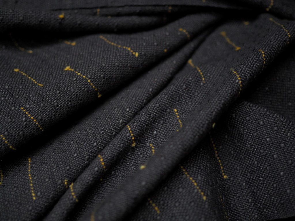 the yellow tsumugi silk words that the mamba slithers through are detailed